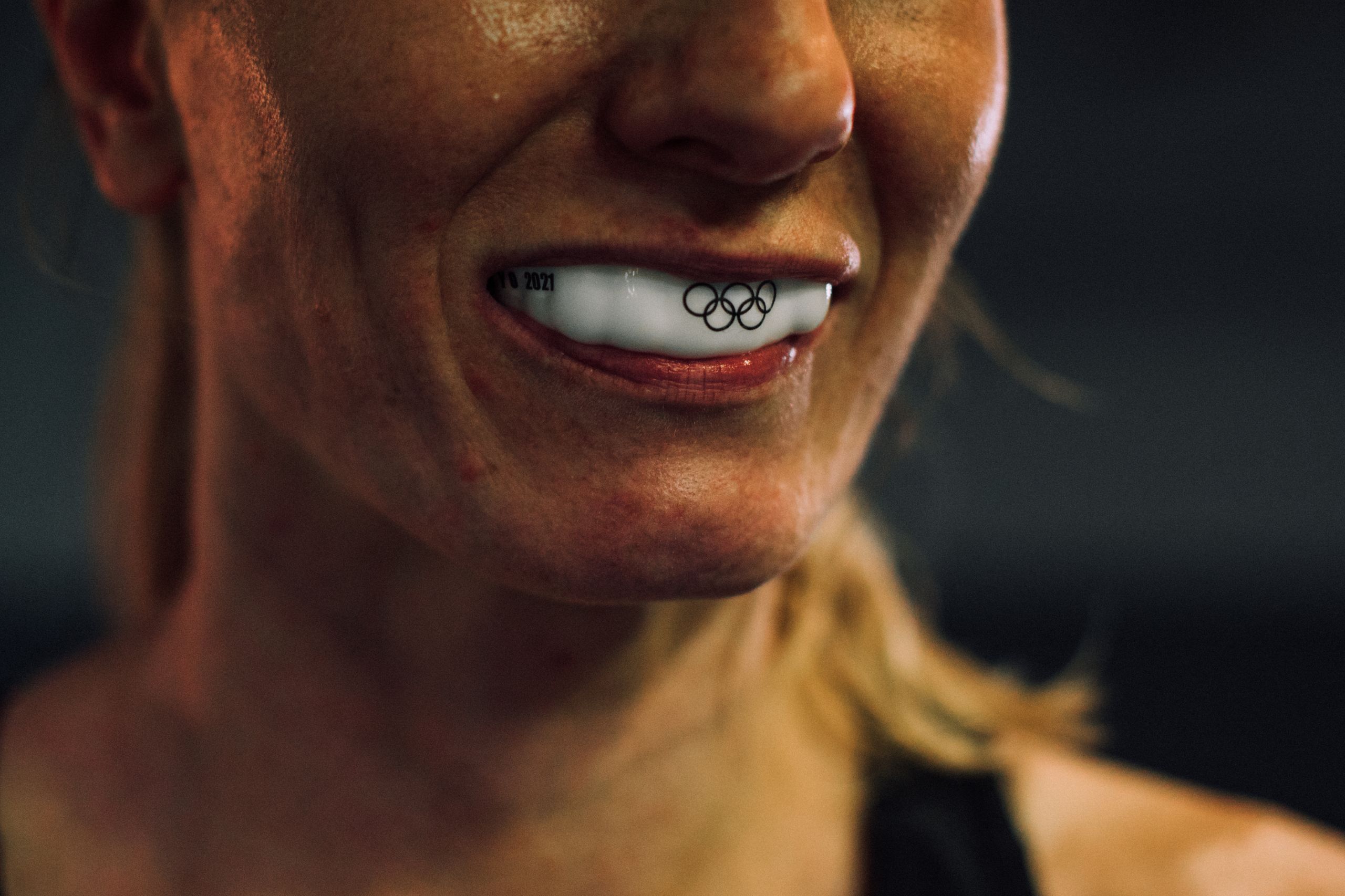 Sleep Apnea Appliances, Mouth and Sports guards 4 Close-up shot showcasing an athlete's mouthguard with Olympic rings engraving.